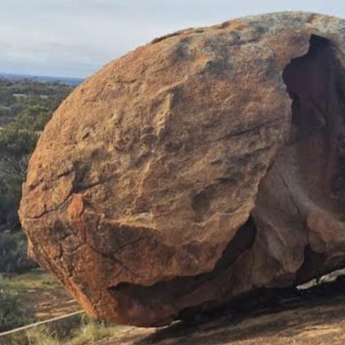 A big rock on top of the mountain