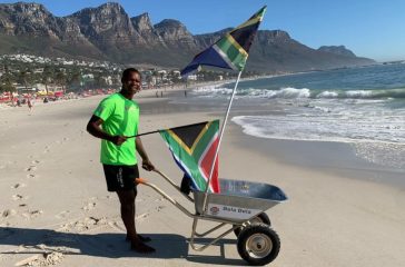 Boikie Monareng with his Wheelbarrow at an Ocean in Cape Town