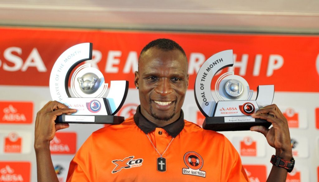 Former Polokwane City and Mamelodi Sundowns striker Rodney Ramagalela holding Absa Premiership goal of the moth and player of the month trophies.